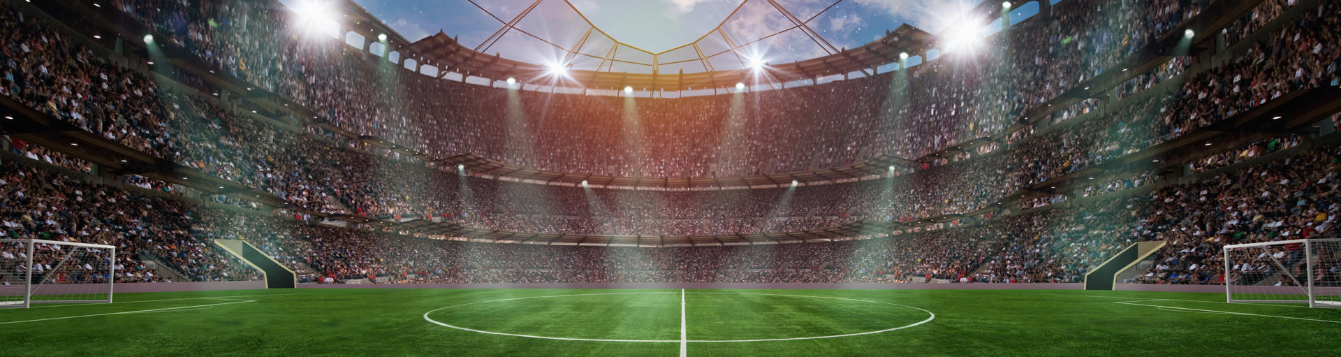Panoramablick auf ein vollbesetztes Fußballstadion mit Flutlicht, bereit für ein WM-Spiel