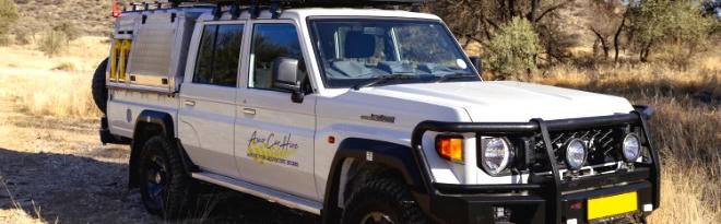 Premium P Landcruiser DC 2.8TD von Asco Car Hire in trockener Landschaft in Namibia